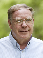 Chip Goehring, Founder of the American Macular Degeneration Foundation - head and shoulders of white man with eyeglasses, smiling, wearing a white collared shirt. 
