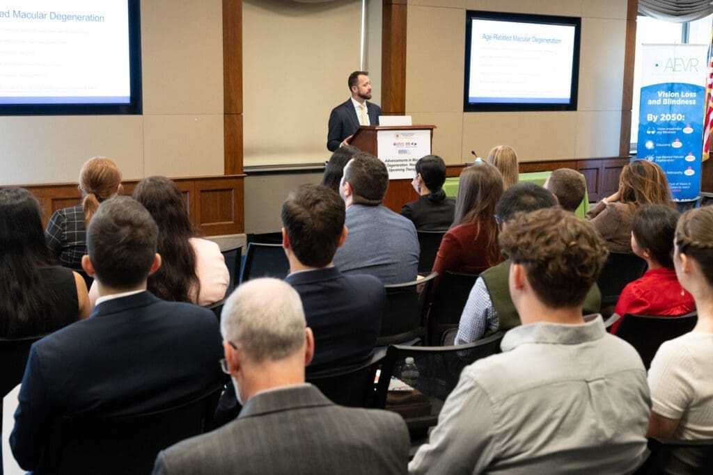 Dan Igneszewski of AEVR at podium during 2023 congressional briefing: Advancements in Macular Degeneration: New and Upcoming Therapies.